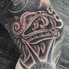 a man's arm with tattoos on it