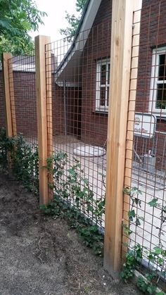 the fence is made of wood and wire