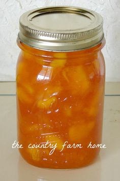 a jar filled with oranges sitting on top of a table