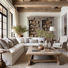 a living room filled with furniture and lots of windows