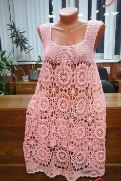 a pink crocheted top is on display