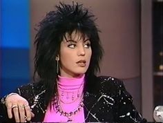 a woman with black hair and pink shirt on the television show michael jackson, jr