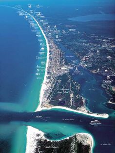 an aerial view of the beach and ocean from above, with blue water in the foreground