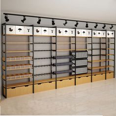 an empty room with several shelves and bins