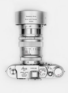 a black and white photo of a camera with its lens attached to the back of it