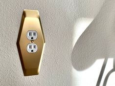 an electrical outlet is shown in the shape of a hexagonal object with two outlets