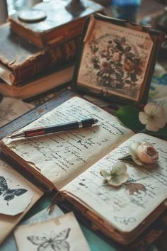 an open book sitting on top of a table next to some flowers and other items