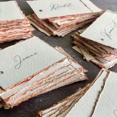 several pieces of paper with writing on them sitting on top of each other in rows