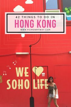 a woman standing in front of a red building with the words, 42 things to do in hong kong