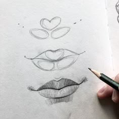 someone is drawing faces with pencils on paper