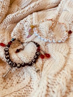 three different bracelets sitting on top of a white blanket