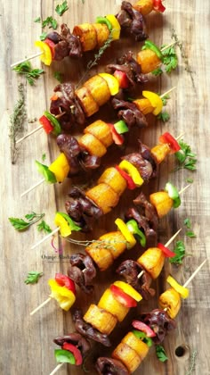 several skewers of meat and vegetables on sticks