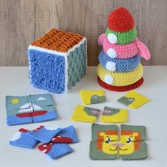 crocheted toys are sitting on a table next to a box and other items