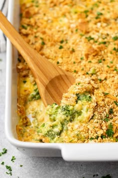 a casserole dish with broccoli, cheese and bread crumbs