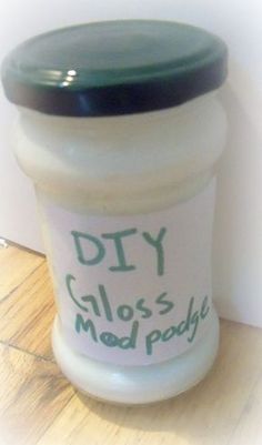 a close up of a jar on a wooden floor with the words diy globs mad poop