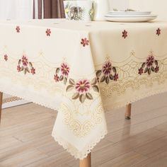 the table cloth is decorated with red flowers