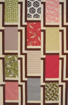 a quilted wall hanging with different colored squares