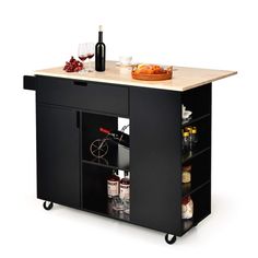 a kitchen island with wine bottles and glasses on it