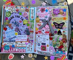 an open scrapbook with lots of stickers and decorations on the pages is shown