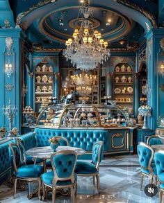 a fancy restaurant with blue velvet booths and chandeliers