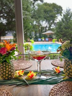 the table is set with pineapples and tropical flowers