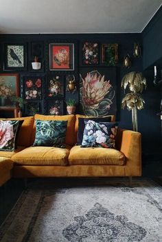 a living room filled with lots of furniture and pictures on the wall next to a rug