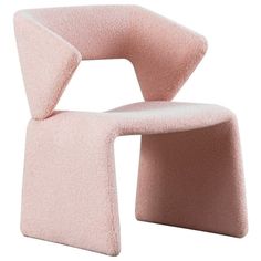 a pink chair sitting on top of a white floor