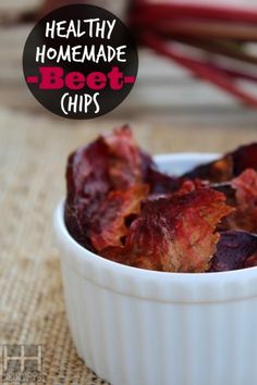 a white bowl filled with beet chips on top of a table next to chopsticks