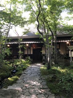 a stone path leading to a house in the woods