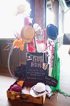 a wooden box filled with lots of hats and other items next to a sign that says happy birthday