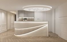 the interior of a modern office with white walls and wood flooring is lit by recessed lighting