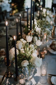 a long table with candles and flowers on it