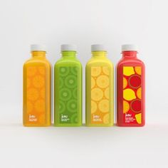 three different types of juice bottles lined up in a row