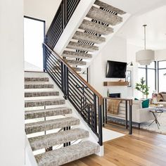 a living room filled with furniture and a stair case