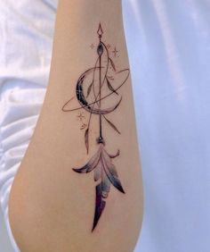 a woman's arm with a tattoo on it that has an arrow and stars