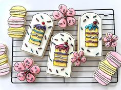 decorated cookies and pastries on a cooling rack