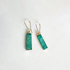 These sparkly drop earrings feature vibrant druzy stones. Secured with gold plated earwire, they'll provide comfort and a fun pop of color. · Druzy · Gold plated brass · kidney earwire · 1.5" drop Crystal Drop Earrings, Brass Gold, Pop Of Color, Gems Jewelry, Crystal Earrings, Druzy, Jewelry Earrings Dangle, Beautiful Jewelry, Dangle Drop Earrings