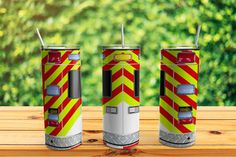 three fire extinguishers sitting on top of a wooden table next to each other