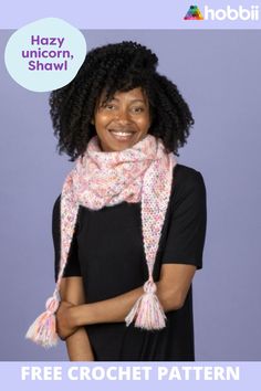 a woman wearing a pink scarf with tassels on her head and smiling at the camera