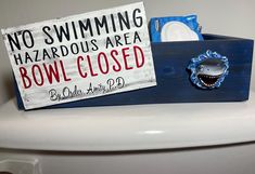 there is a sign that says no swimming hazardous area, bowl closed and shark ring