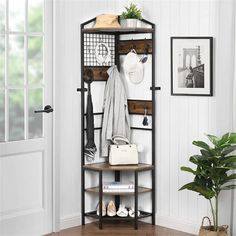 an entryway with a coat rack and shoes