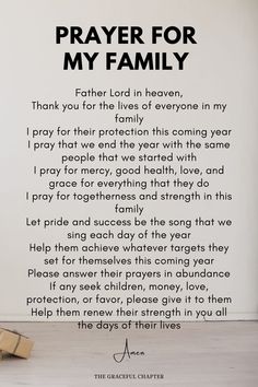 a prayer for my family written in black on a white wall next to two blocks of wood