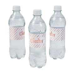 three water bottles with labels on them sitting in front of each other, one empty