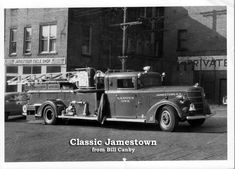 an old fire truck parked in front of a brick building with the words classic jamestown written on it