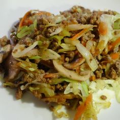 a white plate topped with lettuce and meat