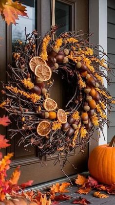 an autumn wreath with oranges and acorns on the front door