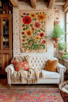 a living room with a couch, rugs and pictures on the wall above it