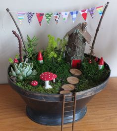 a pot filled with plants and mushrooms on top of a wooden table