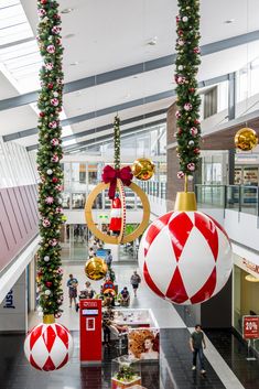 the christmas decorations are hanging from the ceiling