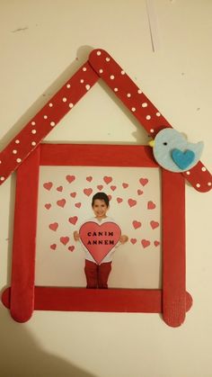 a photo frame with an image of a boy holding a heart in the shape of a house